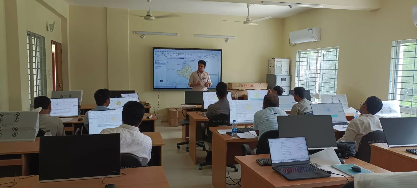Instructor explaining a GIS workflow during a practical computer-lab session