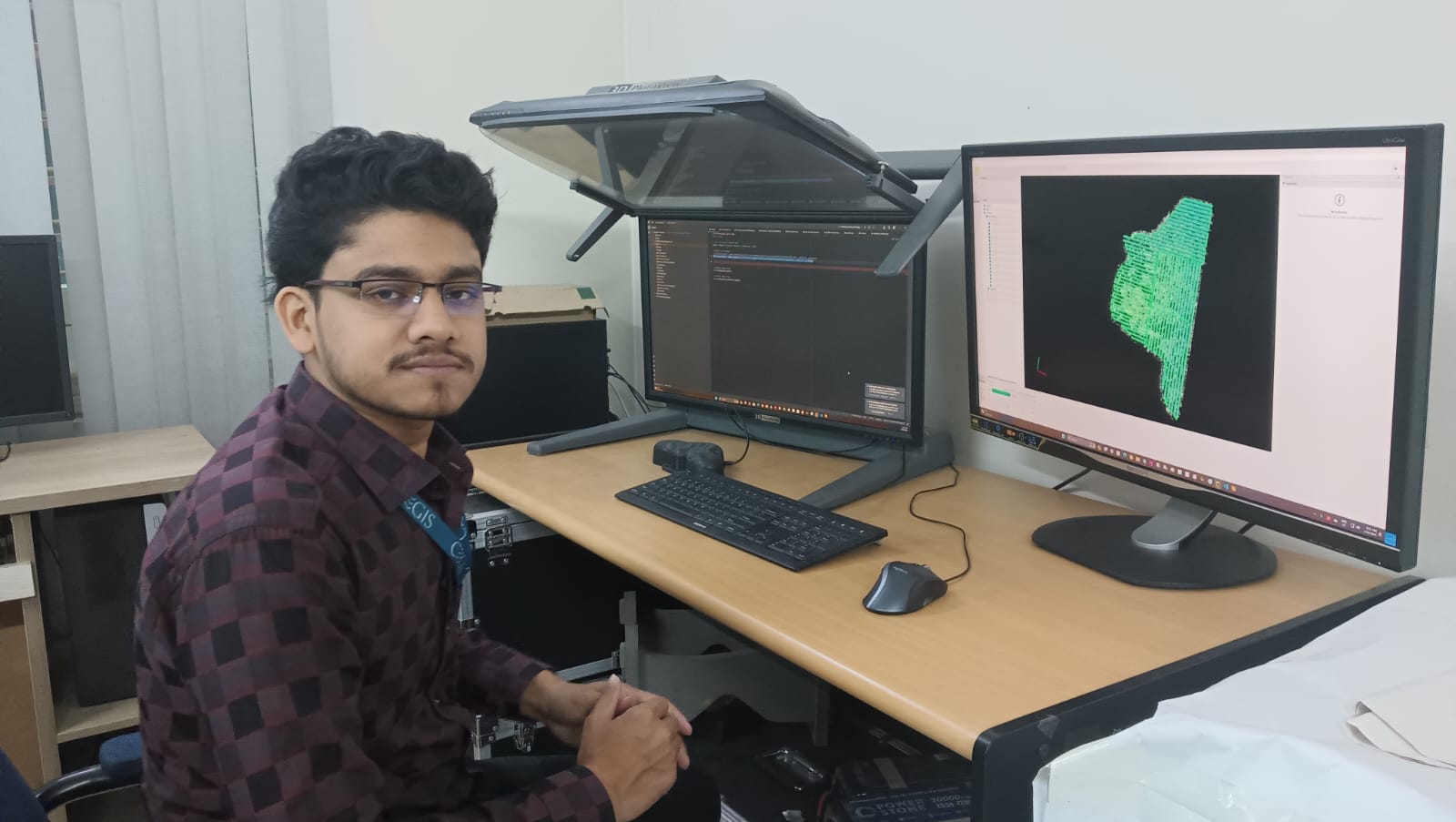 Photogrammetric and GIS processing workstation with spatial datasets displayed on monitors